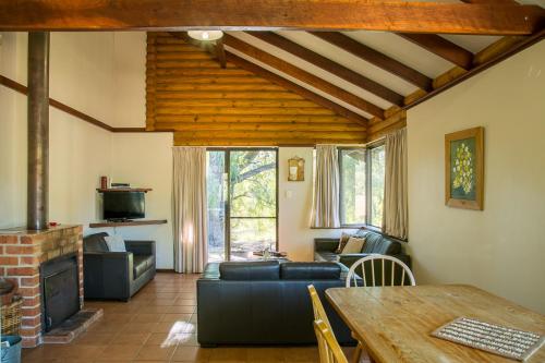 a living room with a couch and a table at Wyadup Brook Cottages in Yallingup