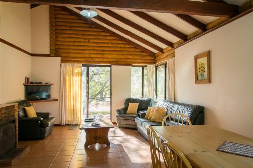 a living room with a couch and a table at Wyadup Brook Cottages in Yallingup