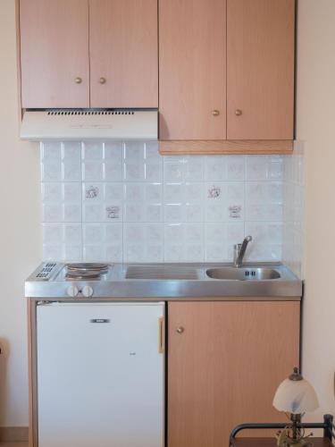a kitchen with a sink and a refrigerator at Apartments Hotel & Studios, Xifoupolis in Monemvasia