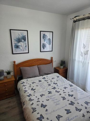 a bedroom with a bed and three pictures on the wall at casa Caithlyn in Peniscola