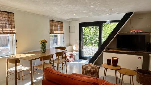 a living room with a table and some chairs at Tidal Nest - North Sea Stays in Wenduine