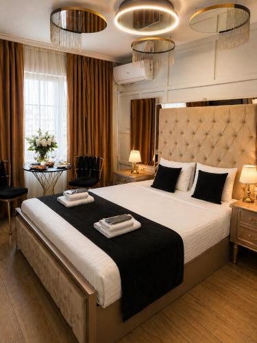 a bedroom with a large bed with two towels on it at Luka Suit Hotel in Istanbul
