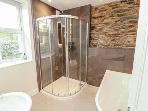 a shower in a bathroom with a sink and a toilet at Rothay Cottage in Ambleside