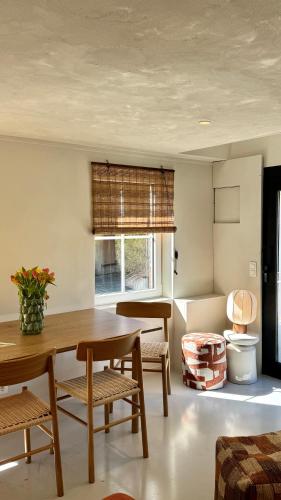 a living room with a wooden table and chairs at Tidal Nest - North Sea Stays in Wenduine