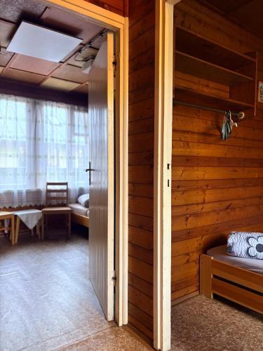 an open door to a room with a bedroom at Chatičky pod Kamínkem Doksy in Doksy