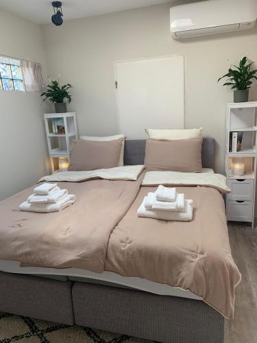 a bedroom with a large bed with towels on it at Mouton Beach Lodge in Petten