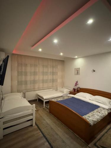 a bedroom with two beds and a large window at Apartment Music in Sarajevo