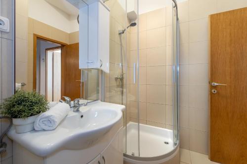 a bathroom with a sink and a shower at Seaview Apartments Tihi II in Vodice