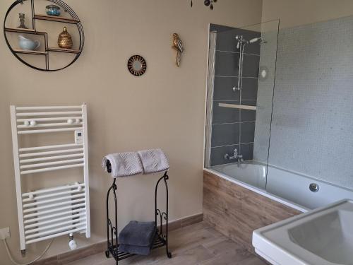 a bathroom with a shower and a tub and a sink at Le Mesnil Landon in Lingèvres