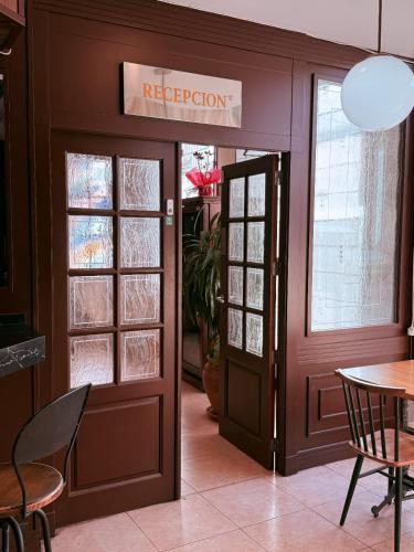 a door to a restaurant with a table and chairs at Hotel Vadorrey in Roa