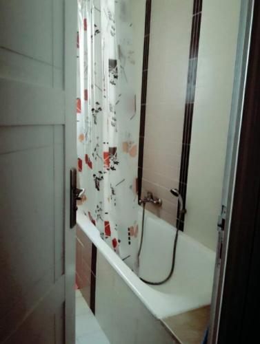 a bathroom with a shower with a shower curtain at Confort house in Nabeul