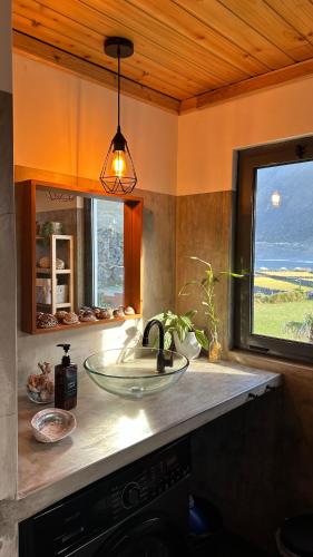 a kitchen counter with a sink and a window at Longitude 31 House in Faja Grande