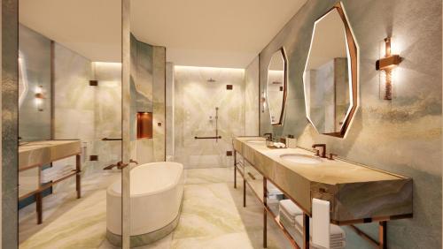 a bathroom with two sinks and a tub and a shower at FAIRMONT NEW ORLEANS in New Orleans