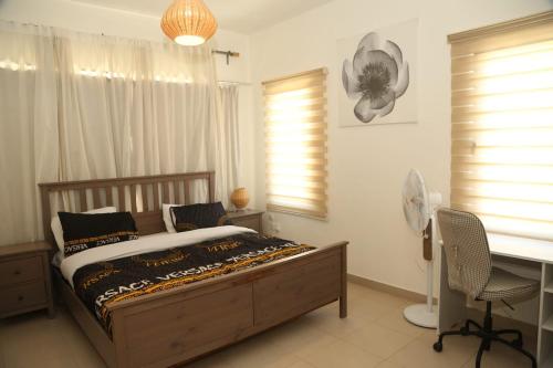 a bedroom with a bed and a desk and a desk at Samarah Resort Apartment D32 at DeadSea, Sea & Pool view- Families & couples only in Sowayma