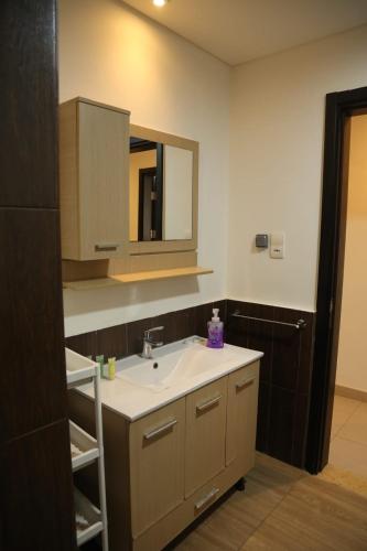 a bathroom with a sink and a mirror at Samarah Resort Apartment D32 at DeadSea, Sea & Pool view- Families & couples only in Sowayma