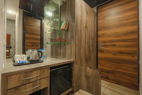 a kitchen with wooden walls and a counter with a appliance at Hotel Heritage Street ! 100m from Golden Temple ! Parking & Restaurant in Amritsar