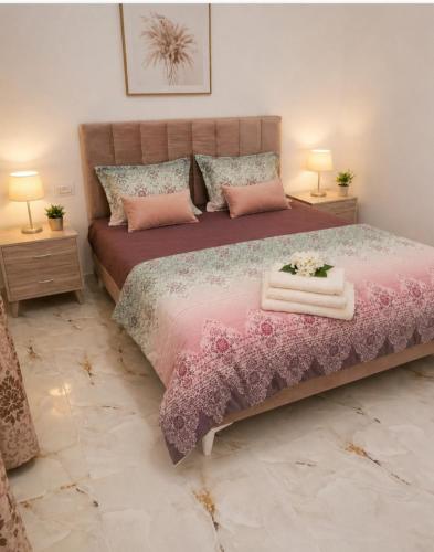 a bedroom with a large bed with flowers on it at Modern and Calm Apartment in Mahdia near Beach in Rejiche