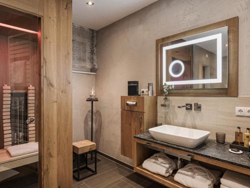 a bathroom with a sink and a mirror at Landhaus Mader Hintertux in Tux