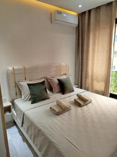 a bedroom with a bed with two towels on it at Riad Andalous in Ariana