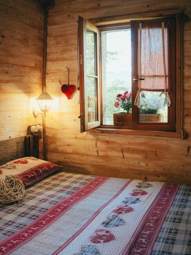 a bedroom with a bed and a window in a room at Il Roccolino in Valsecca