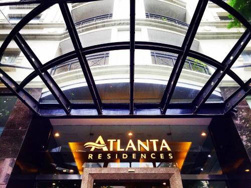 a building with a sign in front of a restaurant at Atlanta Residences in Hanoi