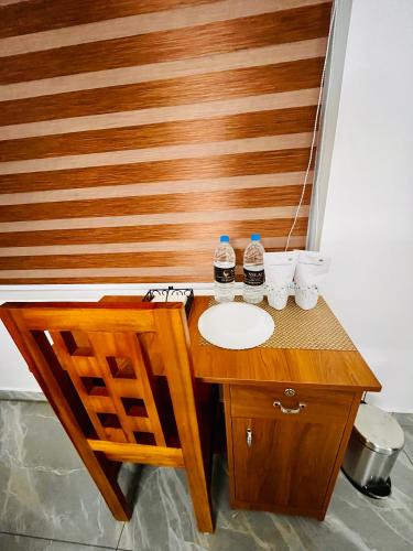 a wooden table with two bottles of water on it at Nilavu villas in Alleppey