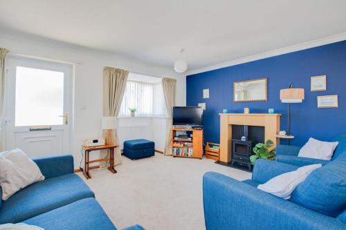 a blue living room with two blue couches and a tv at 2 Bed in Walcott oc-2301 in Walcott