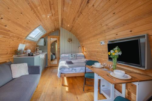 a living room with a couch and a tv in a cabin at 1 Bed in Barnacre oc-b34348 in Catterall