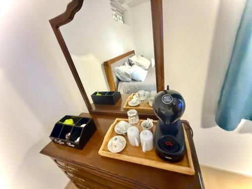 a dressing table with a mirror and a hair dryer on it at Quarto Eixo Atlântico in Bragança
