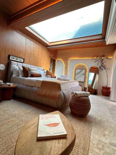 a bedroom with a large bed and a large window at SDesign Paraty Hotel in Paraty