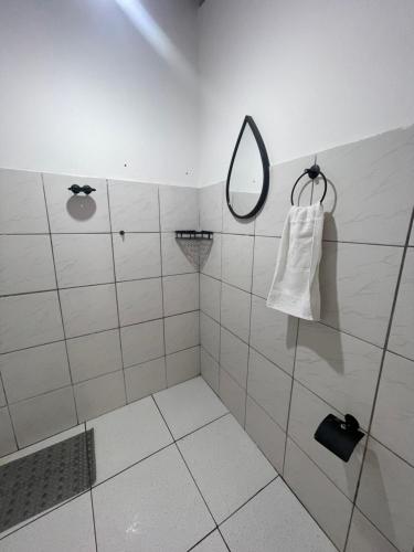 a bathroom with a shower with a mirror at Hospedagem Sousa in Santa Inês
