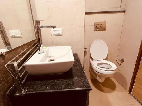 a bathroom with a sink and a toilet at Sukoon studios in Ghaziabad