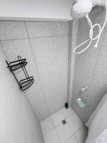 a bathroom with a shower with a glass door at Cabañas La PetiteChef in El Limar