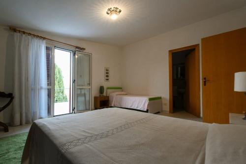 a bedroom with a large bed and a window at Casa La Pigna in Lucito
