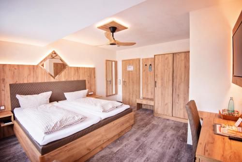 a bedroom with a bed and a desk at Landhaus Eden 3 Sterne Superior in Soltau