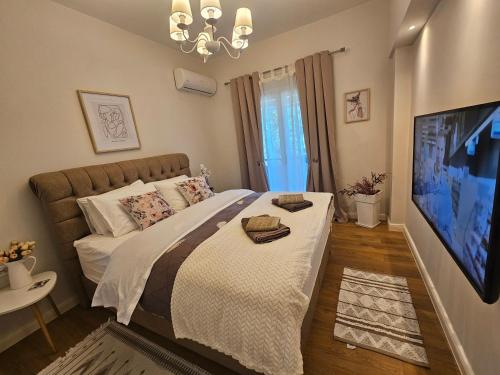 a bedroom with a large bed and a tv at Eda house in Gouvia