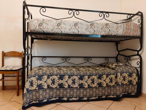 two bunk beds in a room with a chair at Casa Radiosa in Sora