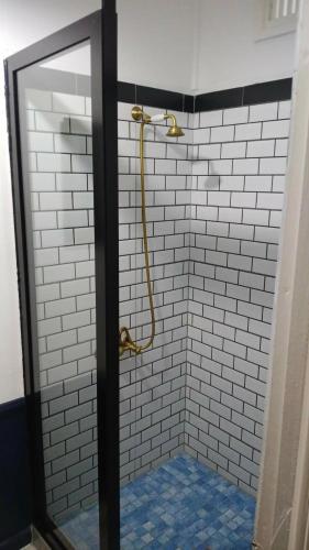a bathroom with a shower with a mirror at The Samoan Outrigger Hotel in Apia