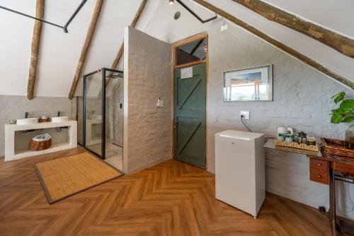 a bathroom with a shower and a glass door at River House Lodge in Malelane