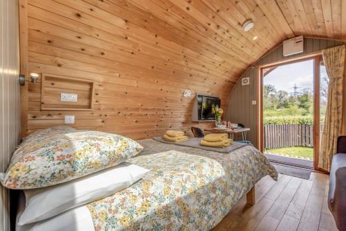 a bedroom with a bed and a wooden wall at 1 Bed in Barnacre oc-w34347 in Catterall