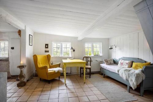 a living room with a bed and a yellow table at AE326-Marstal-Pers-Bro-6 in Marstal