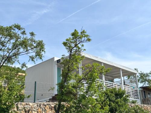 a house on a hill with trees in the foreground at Adriastay 360 in Klenovica