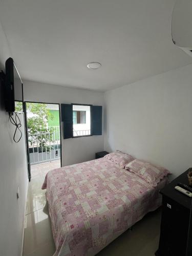 a bedroom with a bed and a television in it at CASA FLOR DE LIZ in Villavieja