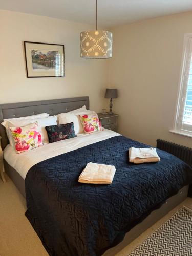 a bedroom with a large bed with two towels on it at 31 Sailsbury road in Marlborough