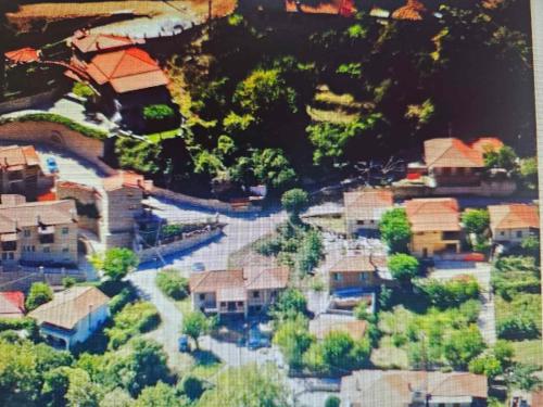 a model of a village with houses and a road at Ζachlorou Inn in Kalavrita