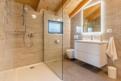 a bathroom with a shower and a toilet and a sink at Villa Lareva - sunset view in Ustrine