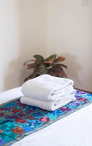 a stack of towels sitting on a table at Bacanda Hotel in Puerto Escondido