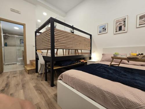 a bedroom with a bed and a desk and a shower at Loft Centrico Tantín RH 17 in Santander