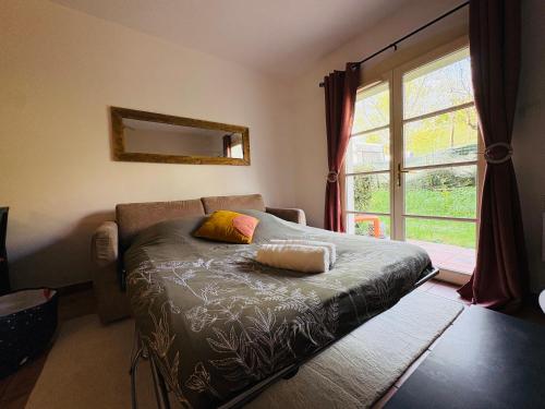 a bedroom with a bed and a large window at Le Vercors Park in Die