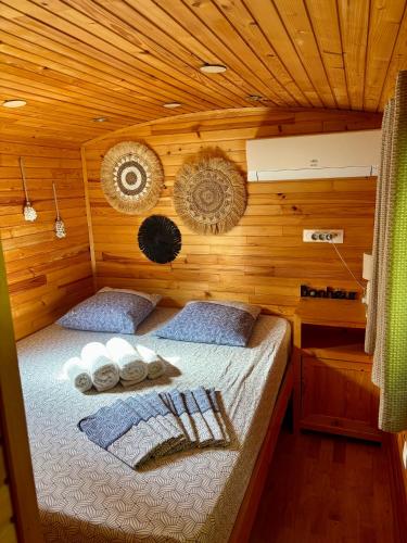 a bedroom with a bed in a wooden cabin at Des roulottes en Provence in Barbentane